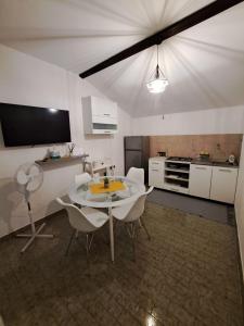 a kitchen with a table and chairs in a room at Kuća za odmor TONI in Zaglav