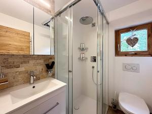 a bathroom with a glass shower and a sink at Natur, Erholung, moderne 35m2 für 2P mit Auto PP - SP19 in Pontresina