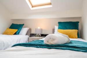 a white stuffed animal sitting on top of two beds at Deluxe Apartment in Sheffield City Centre - Sleeps 6 in Sheffield