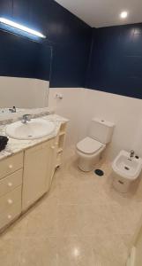 a bathroom with a sink and a toilet at CarihuelaCity in Torremolinos