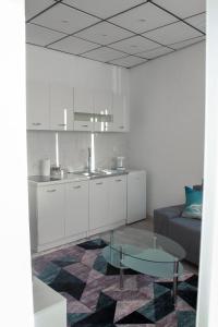 a kitchen with a couch and a table in a room at Apartmani Golub in Livno