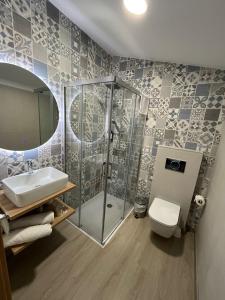 a bathroom with a shower and a sink and a toilet at Casona de ventas in Portomarin