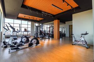 a gym with several treadmills and exercise bikes in it at 1 bedroom Condo in Westlands with Pool and Gym in Nairobi