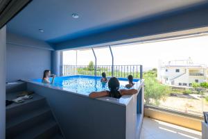 a group of people in a hot tub with a view at Grand Suites with Private Pools in Kalamata