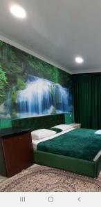a bedroom with a waterfall mural on the wall at Гостевой дом ЛОНТАНА in Gagra