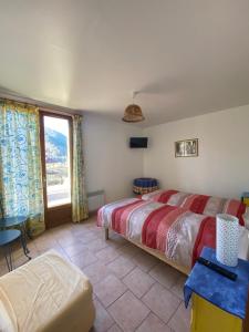 1 dormitorio con 2 camas y ventana grande en Ferme-auberge le cochon du Madres, en Escouloubre