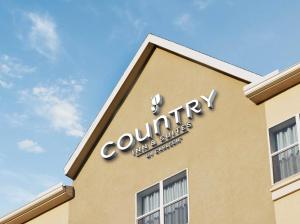 a company sign on the side of a building at Country Inn & Suites by Radisson, Clarksville, TN in Clarksville