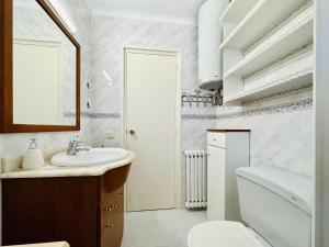 a white bathroom with a sink and a toilet at Ambient CostaBravaSi in Platja d'Aro +15 photos