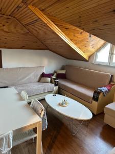 a living room with a couch and a table at 2 Room 1 bathroom 1 Kitchen 3-4 people in Istanbul