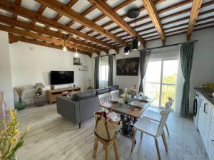 a living room with a table and a couch at El rincón de Vejer. Vistas exclusivas y únicas. in Vejer de la Frontera