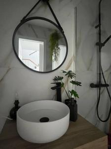 a bathroom with a large white sink and a mirror at El rincón de Vejer. Vistas exclusivas y únicas. in Vejer de la Frontera +20 photos