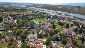 an aerial view of a residential suburb next to a river at Pedras D'el Rei in Tavira