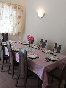 a dining room table with a purple table cloth at Gorgeous 5 bedroom house in Hither Green