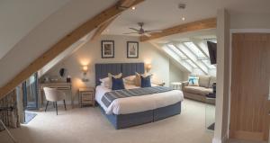 a bedroom with a bed and a desk in a room at Waterfront House in Dartmouth