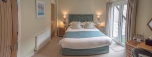 a bedroom with a large bed and a window at Waterfront House in Dartmouth