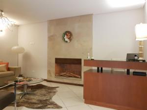 a living room with a couch and a fireplace at Casa Garay Hotel 658 in Asuncion