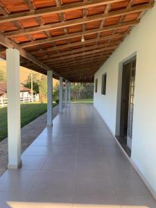 an empty hallway of a building with a wooden ceiling at Recanto Bellini's in Barreira +19 photos