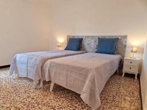 Giường trong phòng chung tại Giardino panoramico sul mare, un angolo di liguria