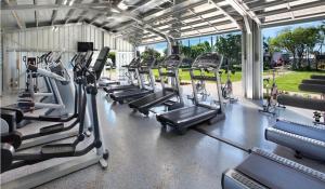 a gym with rows of treadmills and machines at Kiahuna Plantation Renovated 1br, Private Lanai, AC 411 in Koloa