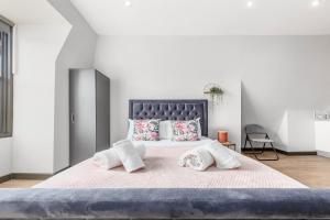 a bedroom with a large bed with two towels on it at Sydenham Stays by Hayes Residency in London