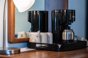 a black coffee maker sitting on a wooden table at Stage Run by the Sea in Ogunquit