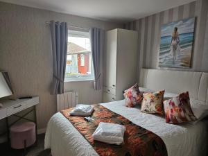a bedroom with a bed with two towels on it at Beautiful & Stunning 1-Bed Chalet in Bridlington in Bridlington