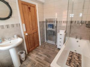 a bathroom with a sink and a tub and a toilet at The Old School House in Scarborough +19 photos
