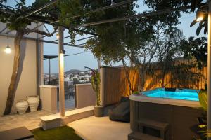 a backyard with a hot tub on a patio at Villa Val-Gio in Ermoupoli