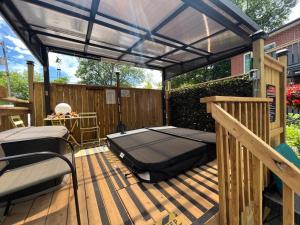 a patio with a bed on a deck at Adrians Wasaga Beach in Wasaga Beach