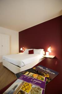 Postel nebo postele na pokoji v ubytování Hotel Leon D'Oro