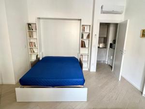 a bed with a blue mattress in a room at Casa Genova 1/2/3 in Turin
