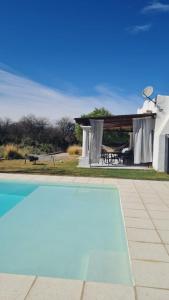a swimming pool in front of a house at CASA CAFAYATE LA SOÑADA in Cafayate