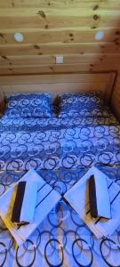 a bed with two napkins on top of it at Cottage 1600 Bosaca in Nikšić