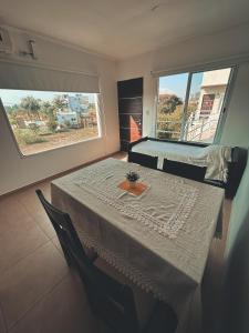 a room with a table and a bed in a room at Buenos Vientos Complejo - Termas Chajarí in Chajarí