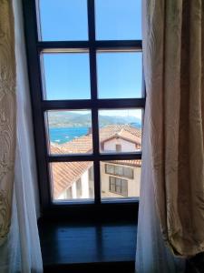 a window with a view of a building at Villa Sv Sofija Old Town in Ohrid