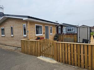 a wooden fence in front of a house at Beautiful & Stunning 1-Bed Chalet in Bridlington in Bridlington