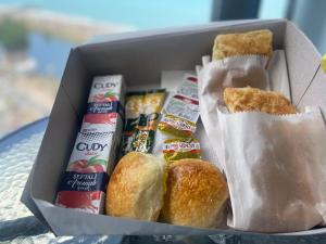 a box of food with bread and other food items at Barakah Apartmets Batumi in Batumi
