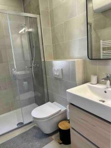 a bathroom with a shower and a toilet and a sink at Villa Ida in Punat