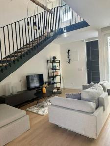 a living room with a couch and a staircase at Villa Ida in Punat