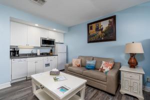 a living room with a couch and a table at Harbour House stunning Studio in Fort Myers Beach