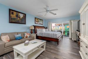 a living room with a bed and a couch at Harbour House stunning Studio in Fort Myers Beach
