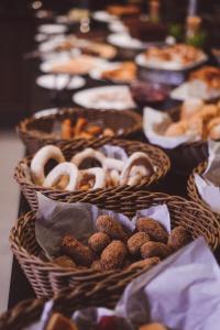 una mesa cubierta con cestas de donuts y bollería en Go Inn Catalão en Catalão