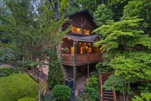 a tree house in the middle of the forest at Stay and Play at The Ryland: Private Game Room & Community Pool Retreat in Gatlinburg