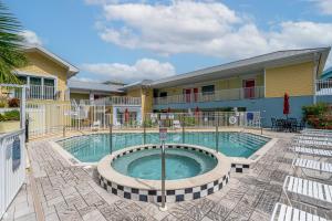 a swimming pool in front of a building at Harbour House stunning Studio in Fort Myers Beach