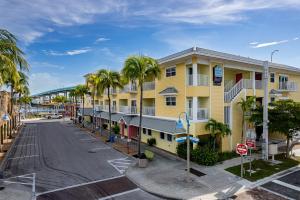 an empty parking lot in front of a yellow building at Harbour House stunning Studio in Fort Myers Beach