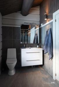 a bathroom with a white sink and a toilet at Luxury log cabing, cross-country ski-in out, familiy getaway in great location in Geilo