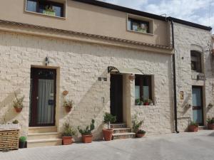a building with potted plants in front of it at Monolocali l'Abbraccio in Ragusa