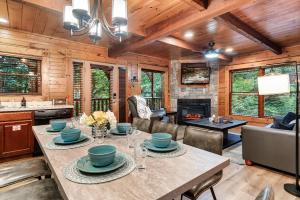 a kitchen and living room with a table and a fireplace at Stay and Play at The Ryland: Private Game Room & Community Pool Retreat in Gatlinburg
