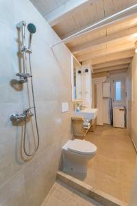 a bathroom with a toilet and a sink at Casa Taila in Ruffano