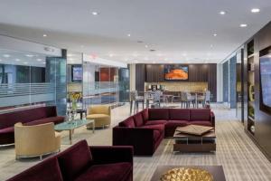 a living room with purple couches and a bar at Luxury Condo in the heart of Crystal City in Arlington